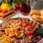 Beef, chicken kebab, bbq with roasted, grilled potatoes, tomatoe