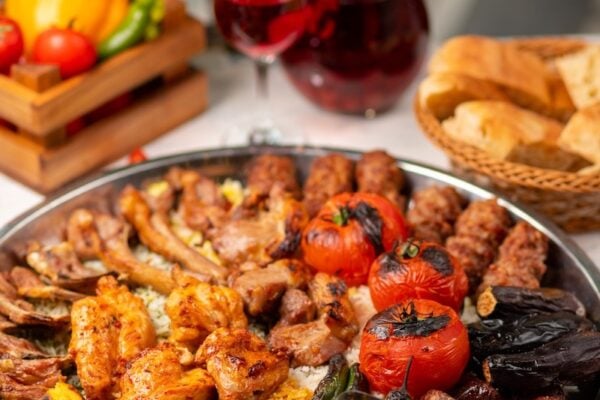 Beef, chicken kebab, bbq with roasted, grilled potatoes, tomatoes and rice. image